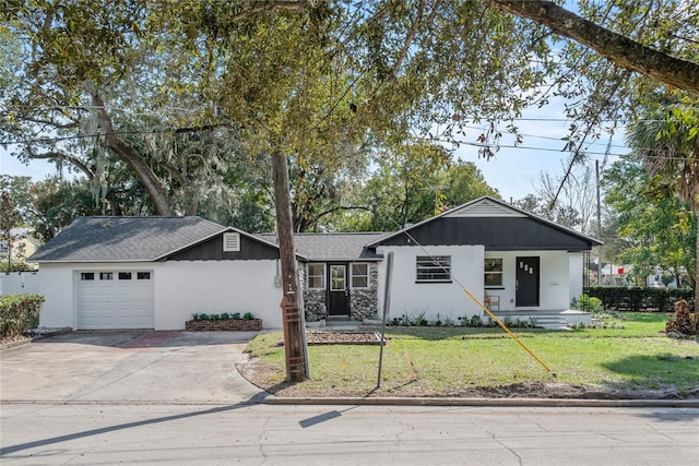 ranch-style house featuring a garage and a front yard