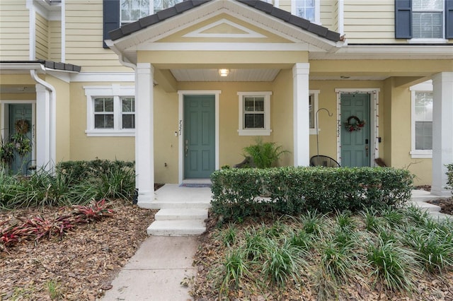 view of exterior entry with a porch