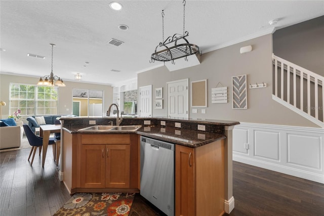 kitchen featuring sink, stainless steel dishwasher, dark hardwood / wood-style floors, an island with sink, and a textured ceiling