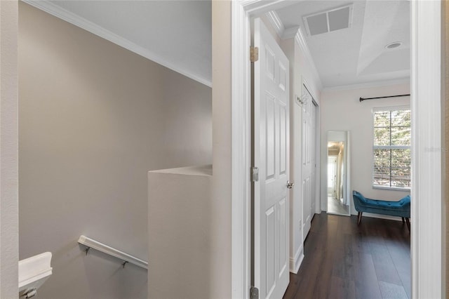 hall with dark wood-type flooring and ornamental molding