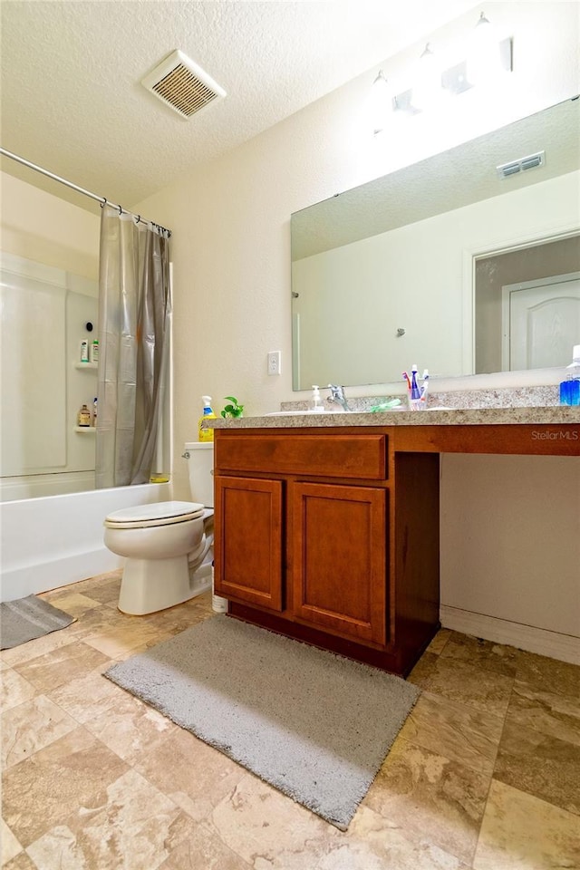 full bathroom featuring vanity, shower / bath combination with curtain, toilet, and a textured ceiling