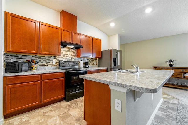 kitchen featuring high end fridge, vaulted ceiling, sink, electric range, and an island with sink