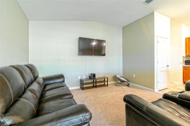 carpeted living room with a textured ceiling and lofted ceiling