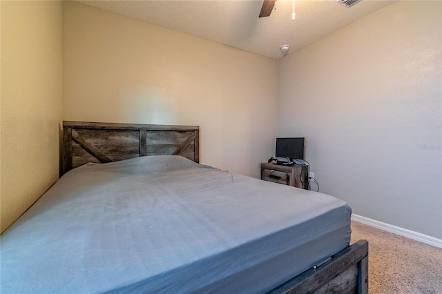 carpeted bedroom with a textured ceiling and ceiling fan