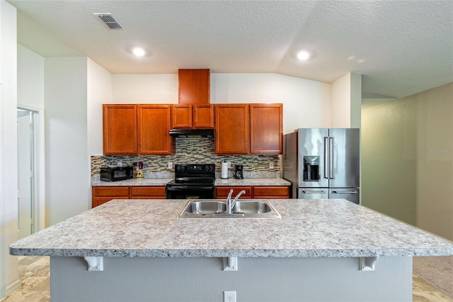 kitchen featuring a center island with sink, black range with electric stovetop, stainless steel fridge with ice dispenser, and sink