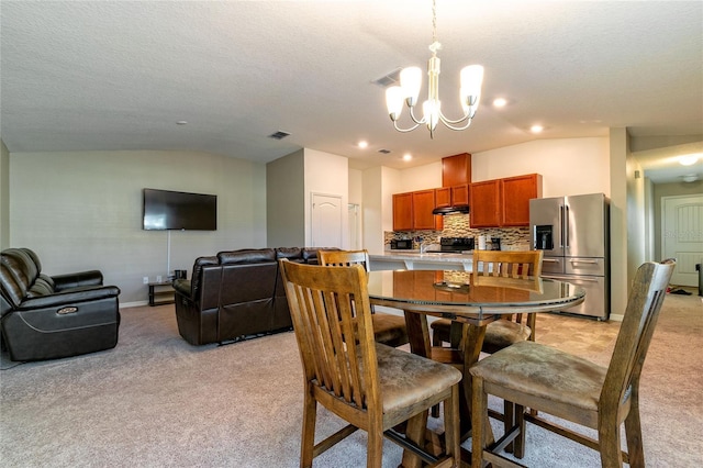 carpeted dining room featuring a textured ceiling, lofted ceiling, and a notable chandelier