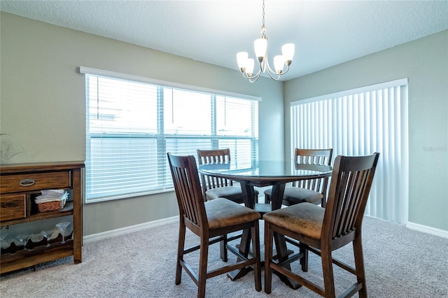 carpeted dining space with a wealth of natural light and a chandelier