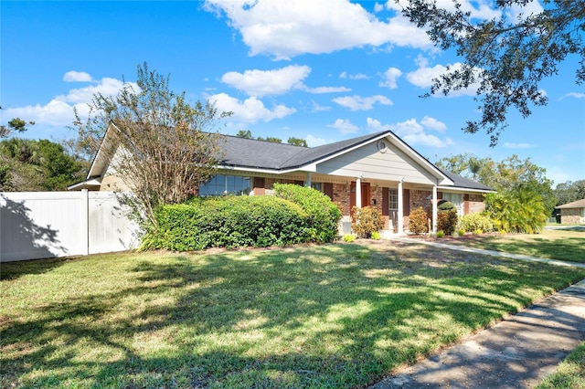 single story home featuring a front lawn