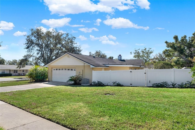 view of front facade featuring a front yard, central AC, and a garage