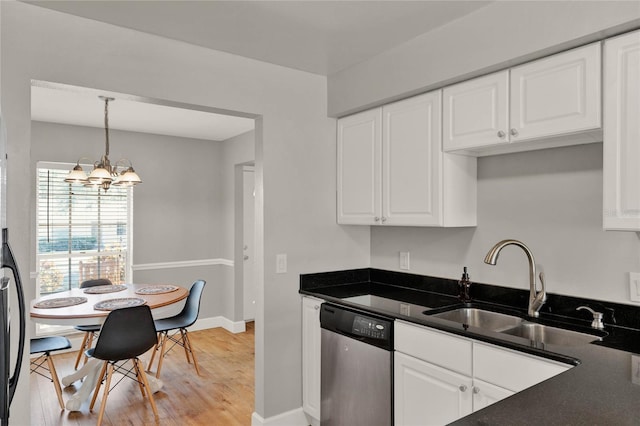 kitchen featuring dishwasher, an inviting chandelier, white cabinets, sink, and light hardwood / wood-style flooring