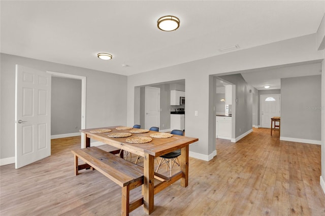 dining space with light hardwood / wood-style floors