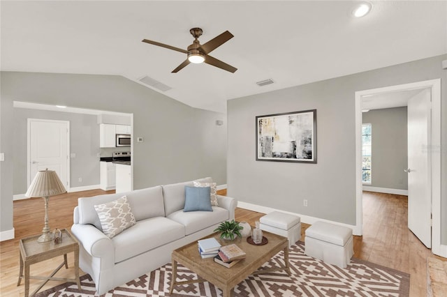 living room featuring light hardwood / wood-style floors, ceiling fan, and lofted ceiling