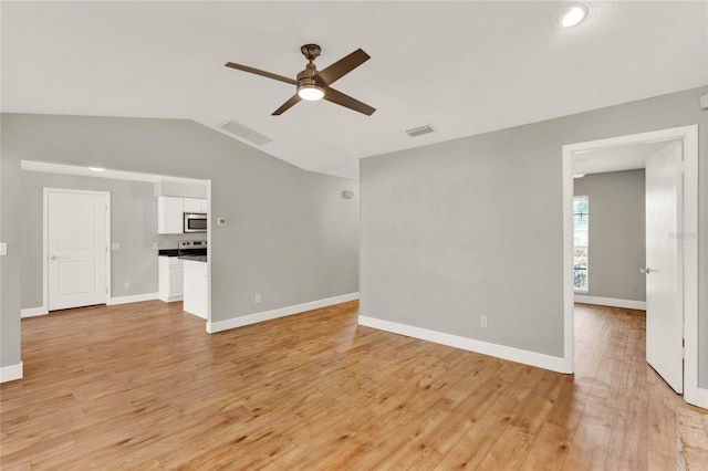 unfurnished living room with ceiling fan, lofted ceiling, and light wood-type flooring