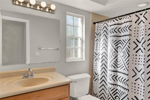 bathroom featuring vanity, a shower with shower curtain, and toilet