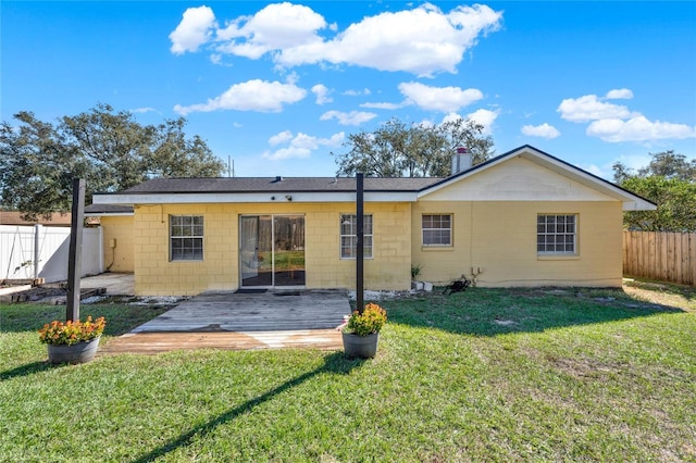 rear view of property featuring a yard