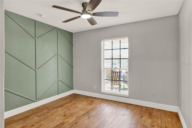 spare room featuring ceiling fan and hardwood / wood-style flooring