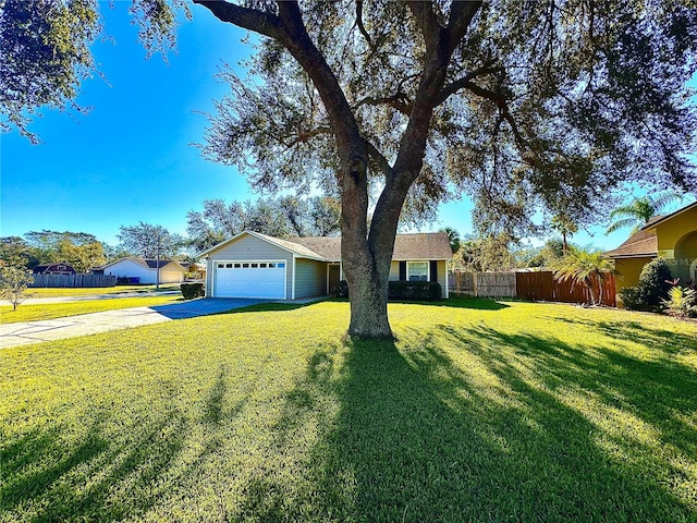 view of front of house featuring a front lawn and a garage