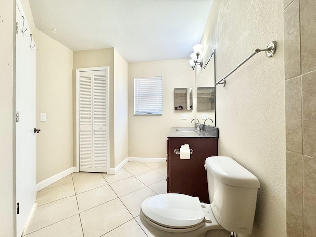 bathroom with tile patterned floors, vanity, and toilet