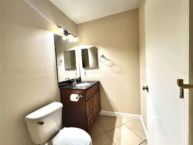 bathroom featuring toilet, vanity, and tile patterned floors