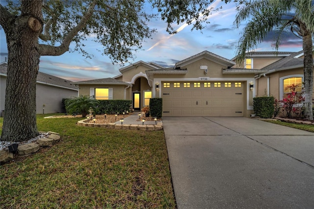 view of front of property with a lawn and a garage