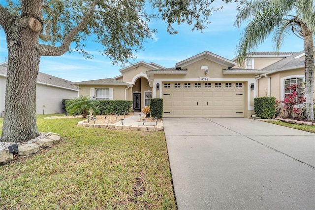 view of front of home featuring a front yard and a garage