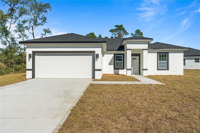 view of front of home with a garage and a front lawn