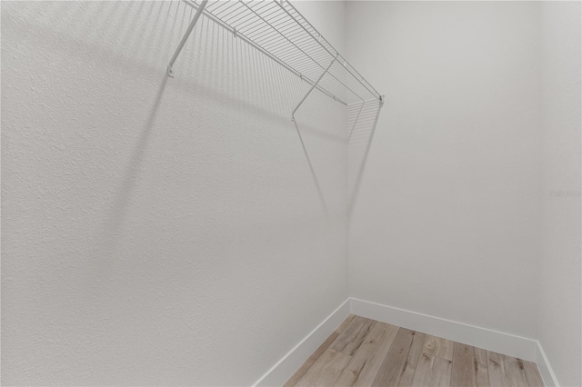 walk in closet featuring light hardwood / wood-style flooring