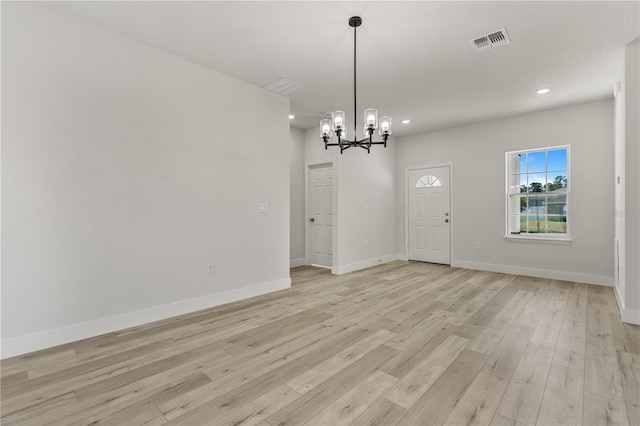 interior space featuring a chandelier and light wood-type flooring