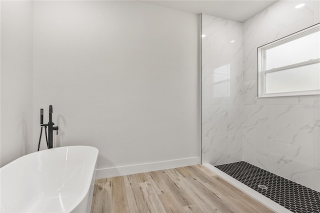 bathroom with plus walk in shower and hardwood / wood-style flooring