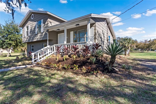 tri-level home with a front lawn and covered porch