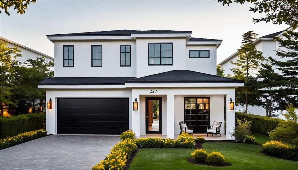 view of front of house featuring a garage and a front yard