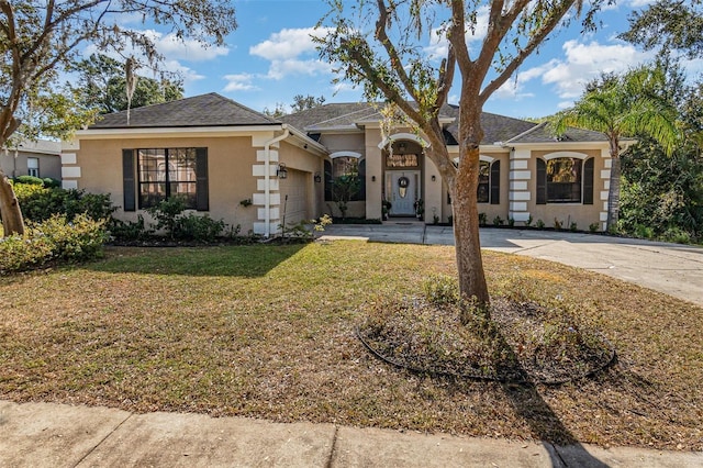 single story home featuring a front lawn and a garage