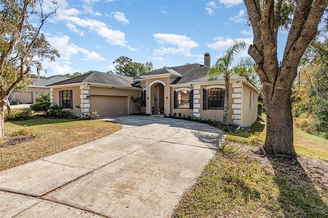 ranch-style house with a front yard and a garage