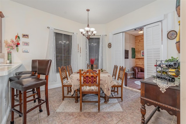 tiled dining area with a chandelier