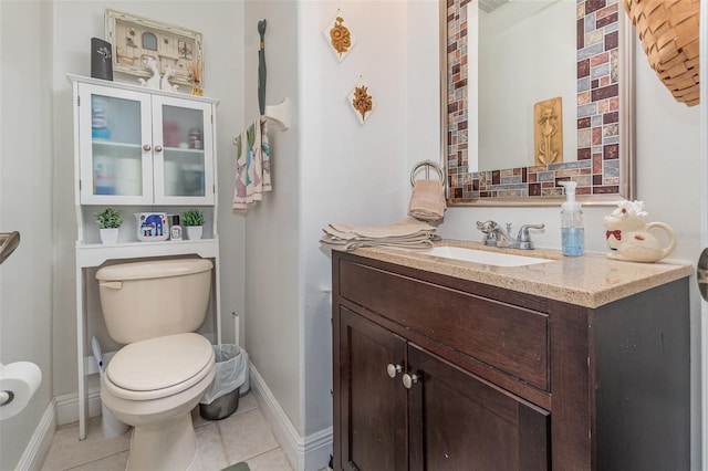 bathroom featuring tile patterned flooring, vanity, and toilet