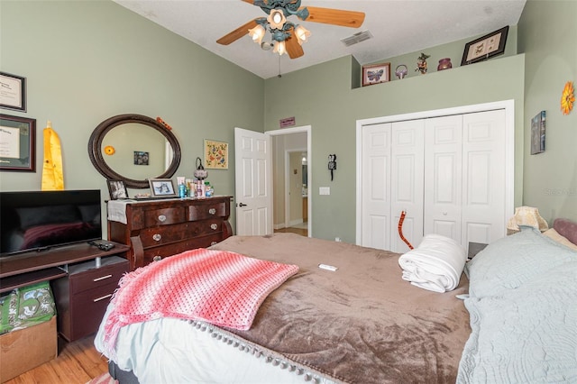 bedroom featuring ceiling fan, a closet, and light hardwood / wood-style floors