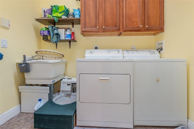 washroom with washing machine and dryer and cabinets