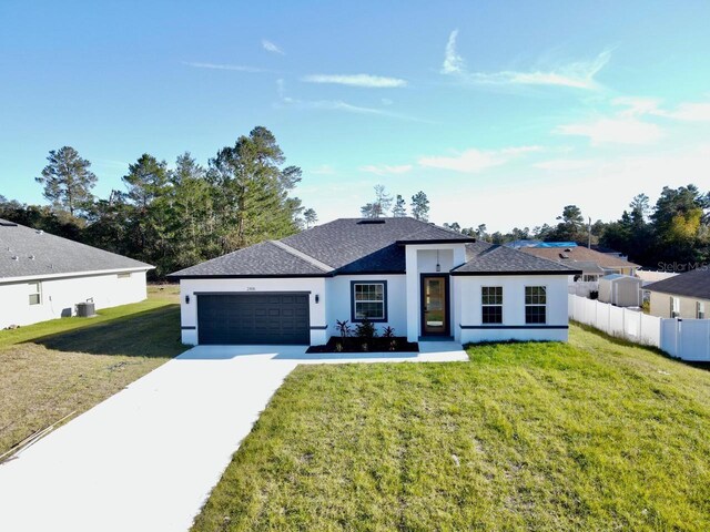 view of front facade featuring a front yard and a garage