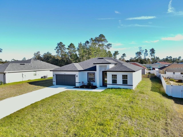 view of front facade with a garage and a front lawn