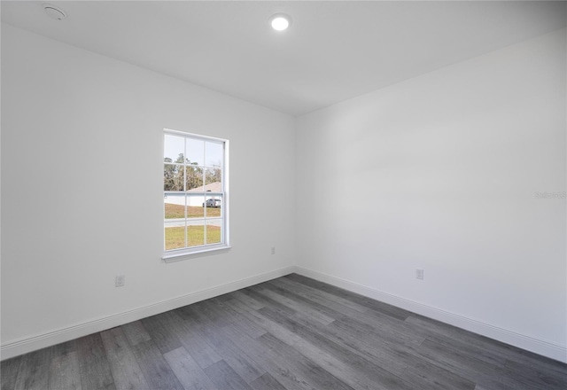 unfurnished room featuring dark wood-type flooring