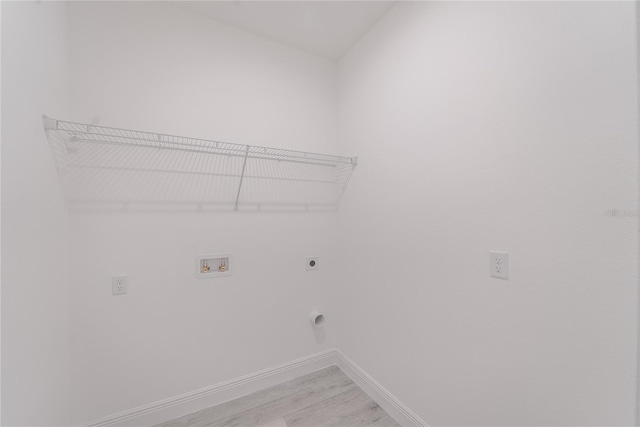 clothes washing area with hookup for a washing machine, light hardwood / wood-style flooring, and electric dryer hookup