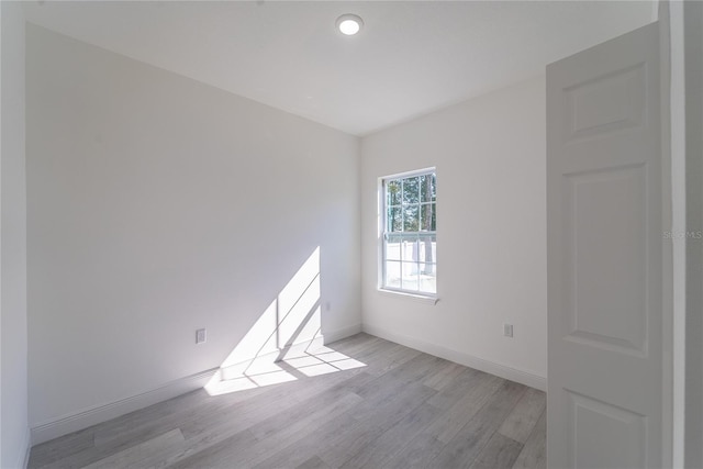 spare room featuring light wood-type flooring