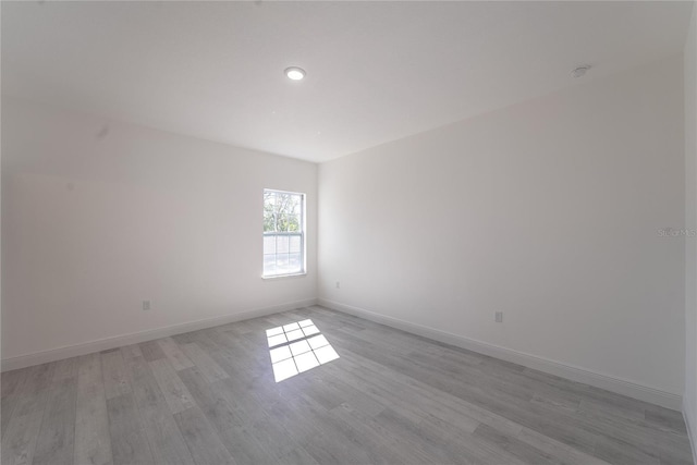 unfurnished room with light wood-type flooring