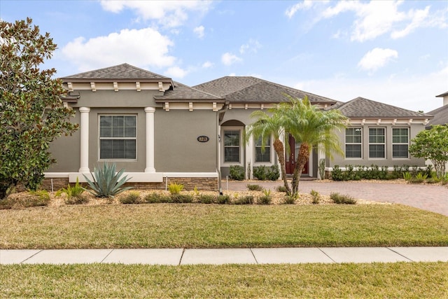 mediterranean / spanish house featuring a front yard