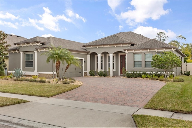 view of front of home featuring a garage and a front lawn