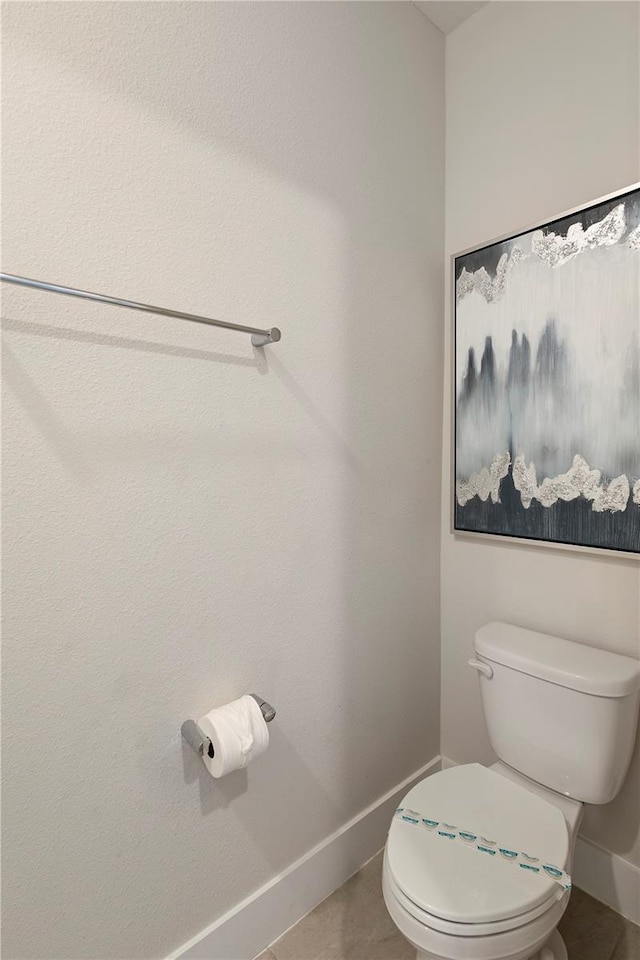 bathroom with tile patterned flooring and toilet