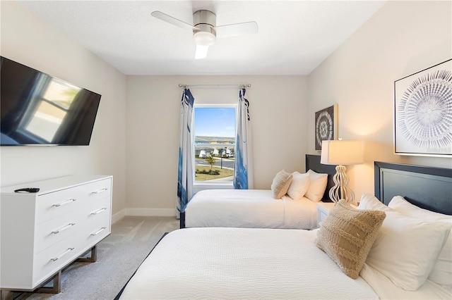 bedroom with light colored carpet and ceiling fan