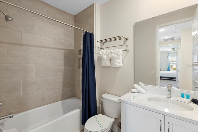 full bathroom featuring shower / tub combo with curtain, vanity, and toilet