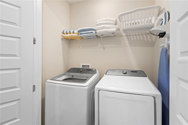 laundry area with independent washer and dryer