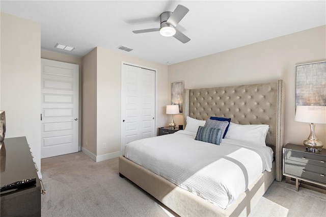 carpeted bedroom with ceiling fan and a closet